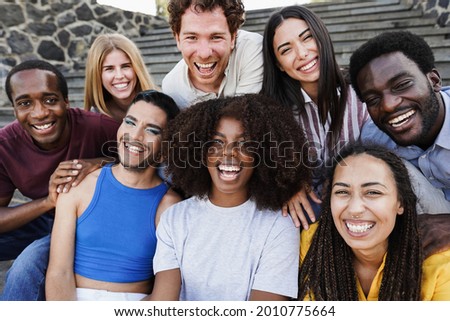 Young diverse people having fun outdoor laughing together - Diversity concept - Main focus on african girl face Royalty-Free Stock Photo #2010775664