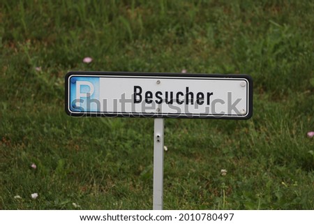 A white street sign for visitors for parking  written in german