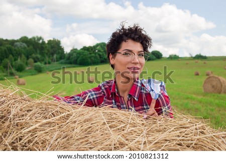 A girl poses on the hay