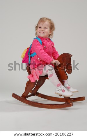 portrait of young child on the wooden horse
