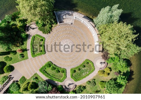 beautiful aerial view of small island with trees, colonnade and multicolored floor mosaic