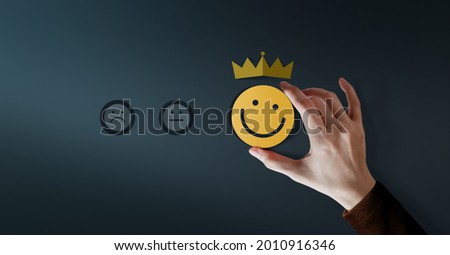 Customer Loyalty Concept. Client Experiences. Happy Customer giving Positive Services Rating for Satisfaction present by Smiling Face and Crown Royalty-Free Stock Photo #2010916346