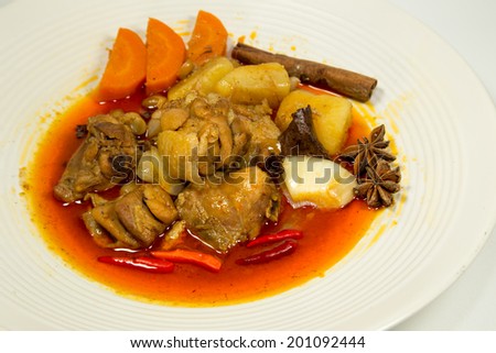 Spicy Muslim chicken curry on white background
