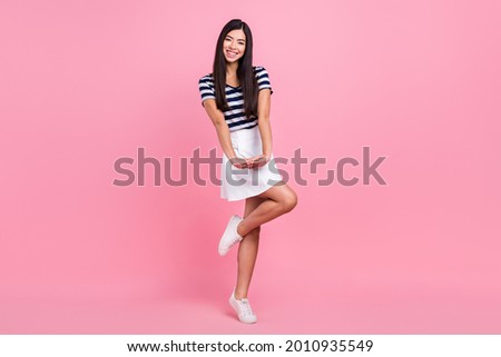 Photo of pretty adorable young woman wear striped outfit dancing smiling isolated pink color background