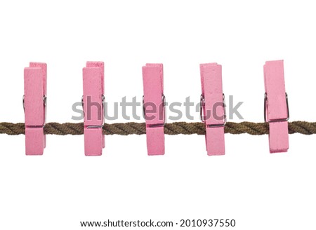Pink clothespins on a rope isolated on white background. Detail for design. Design elements. Macro. Background for business cards, postcards and posters. 