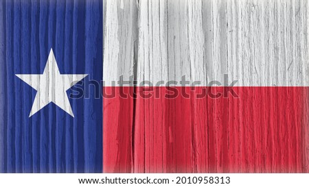 Texas state flag on dry wooden surface. Bright background or wallpaper made of old wood with the symbol of one of the American states. Lone Star State. Edge of the flag has faded like light vignetting