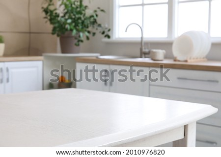 Dining table in interior of modern kitchen Royalty-Free Stock Photo #2010976820