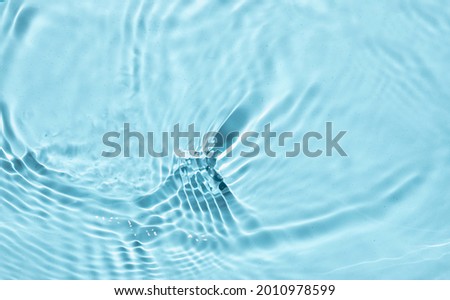 Summer exotic banner. Blurred or defocused transparent  clear  water. Blue liquid colored clear water surface texture with splashes bubbles. 