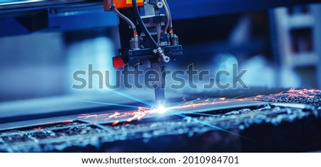 Banner CNC plasma cutting metal iron material with sparks, industry background. Royalty-Free Stock Photo #2010984701