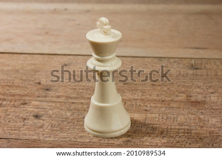 Chess piece of king over wooden table. 