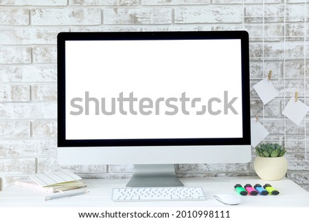 Modern PC monitor with blank screen on table