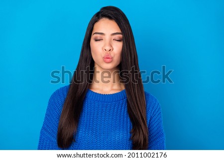Photo portrait young girl sending air kiss on date wearing blue pullover isolated on bright blue color background