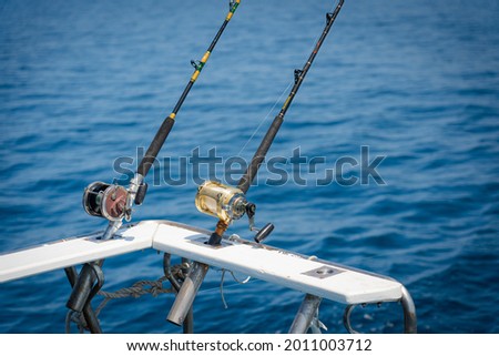 Fishing reels and rods reels for big game fishing trolling tuna.blue sky and blue water.