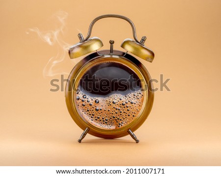 Steamy coffee drink collage. Hot coffee inside of a'larm clock as a symbol coffee time. Royalty-Free Stock Photo #2011007171