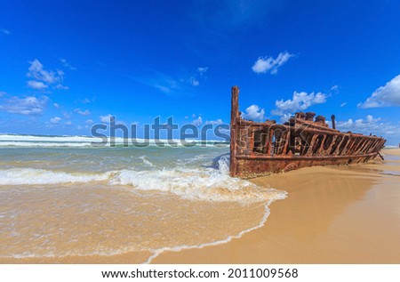 Picture of a rusted shipwreck at Seventy Five Mile Beach on Frazer Island in Australia during daytime