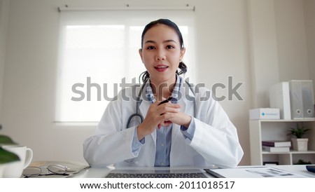 POV screen of young asia people or female doctor live speak talk look at camera work in online clinic help patient on digital telehealth telemedicine smart covid consult VoIP service app on computer. Royalty-Free Stock Photo #2011018517