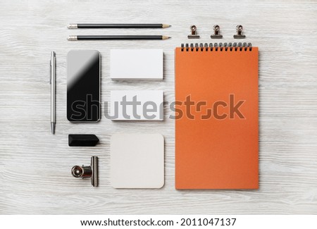 Photo of blank stationery set on light wood table background. Corporate identity template. Responsive design mockup. Top view. Flat lay.