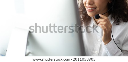 Hispanic woman call center service support in headset. Female customer support or sales agent.  Royalty-Free Stock Photo #2011053905