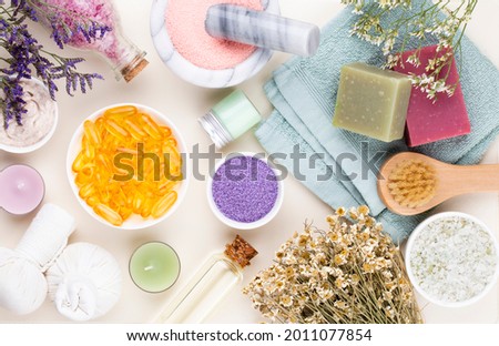 Spa and bath homemade cosmetics. Bottles with spa cosmetic products on pastel background, top view. 