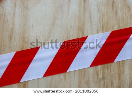 Barrier tape on plywood wall
