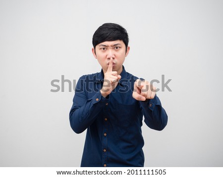 Asian man stance shh serious face point finger at you portrait white background