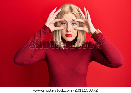 Young blonde woman wearing casual clothes trying to open eyes with fingers, sleepy and tired for morning fatigue 