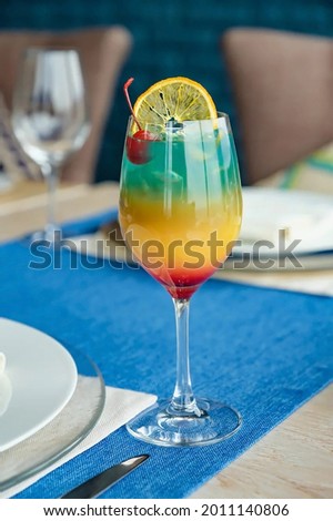 tropical cocktail in a restaurant with a slice of lemon