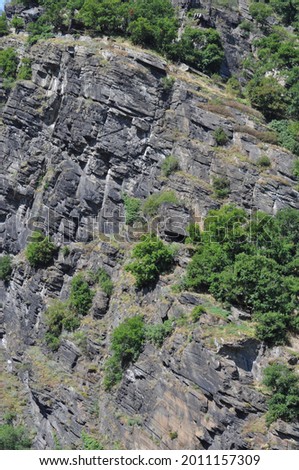 High cliff on the bank of the Rhine river near the town of Koblenz, in Western Germany. Loreley on a summer day. View of cliffs at the Lorelei from a tourist boat. Royalty-Free Stock Photo #2011157309