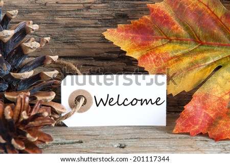 Autumn Background with the Word Welcome written on a label