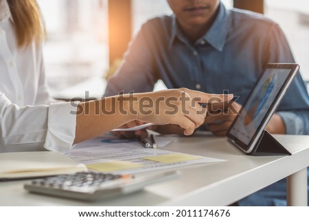 financial advisory services. Asian advisor showing plan of investment to clients in the consultancy office. Royalty-Free Stock Photo #2011174676