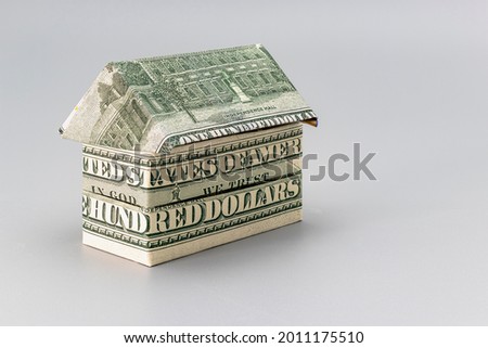 Purchase and sale of housing. Mortgage for the purchase of a house. Rental Property. House folded from dollar banknotes. Origami. Close-up. Copy space. Housing in the USA