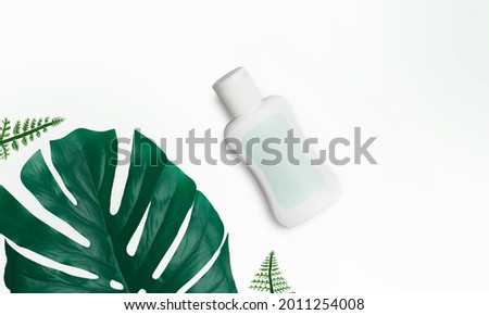 Beauty product package, blank templates of transparent and white plastic containers with tropical leaves isolated on white background - Minimalism style