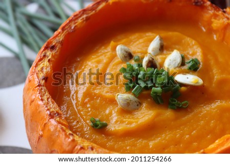 Butternut squash soup close up photo. Creamy soup texture. Healthy eating concept. 