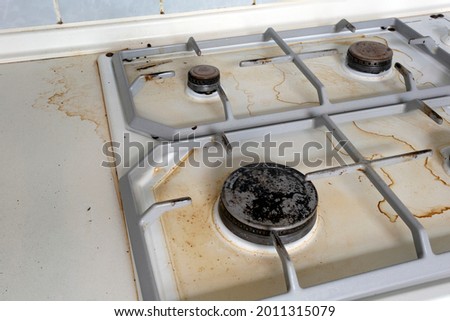 Dirty gas stove cooking oil stains on gas stove in kitchen.An Unclean and Dirty Kitchen used For Cooking Food and Preparing Meals, needs cleaning, close up unhealthy,dirty Royalty-Free Stock Photo #2011315079