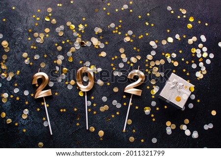Christmas still life with decorative number, sparkles, candy on a gray concrete background. Concept for New Year, Merry Christmas. Christmas background.