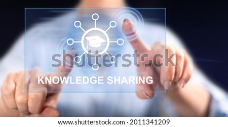 Woman touching a knowledge sharing concept on a touch screen with her fingers