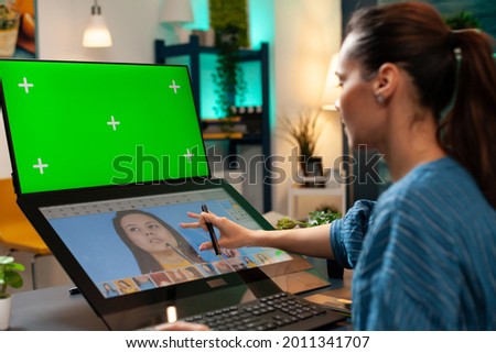 Digital editor using green screen and retouching software for pattern production on computer. Specialist woman with chroma key on display, mockup template and isolated virtual background