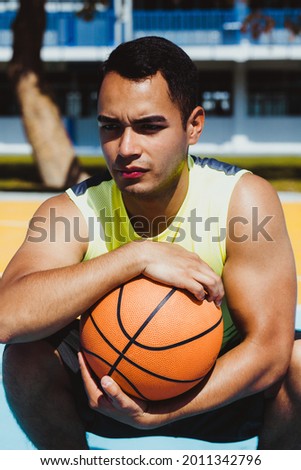 young latin man playing basketball portrait in Mexico