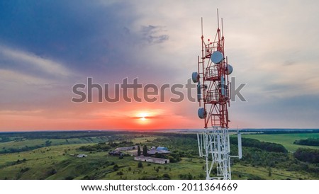 Telecommunication tower Antenna at sunset. Technology on the top of the telecommunication GSM 5G and 4G tower Royalty-Free Stock Photo #2011364669