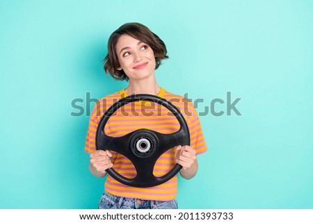 Photo of dreamy adorable woman dressed striped t-shirt smiling driving car looking empty space isolated teal color background Royalty-Free Stock Photo #2011393733