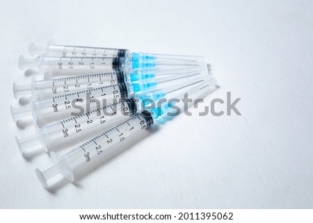 A hypodermic injection syringe. Syringes with blue needles. Medical Injectors. Copy space. High quality photo Royalty-Free Stock Photo #2011395062