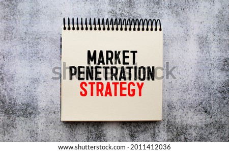 Business and finance concept. On the table is a notebook, a pen and a business card with the inscription - MARKET PENETRATION
