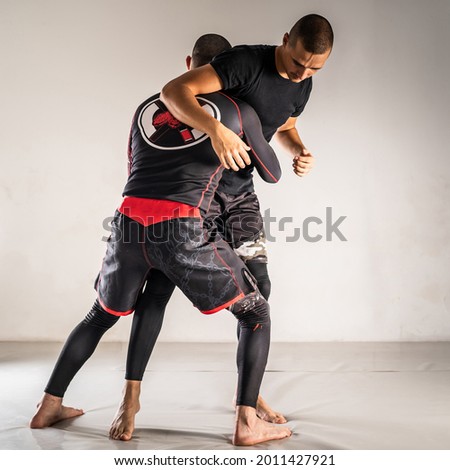 Brazilian jiu jistu bjj no-gi grappling training two male athletes drilling technique takedown wrestling