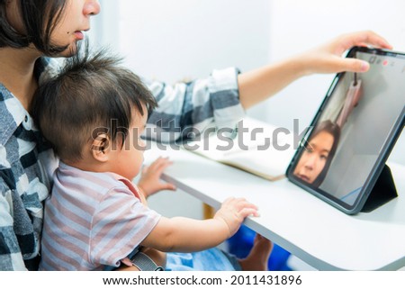 Little girl and sister looking cartoon at the tablet, child addicted to cellphone, excessive use of cellphones.