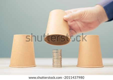 Find a money, guess where is the money, closeup hand reveal the right position of coins heap in three cups shell game