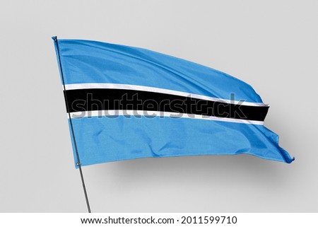 Botswana flag isolated on white background. National symbol of Botswana. Close up waving flag with clipping path.