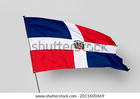 Dominican Republic flag isolated on white background. National symbol of Dominican Republic. Close up waving flag with clipping path.