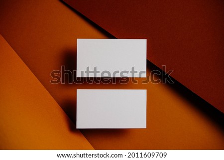 Stylish white blank paper mockup on a colorful background. Business card, document and presentation stationery creator. Selective focus on paper