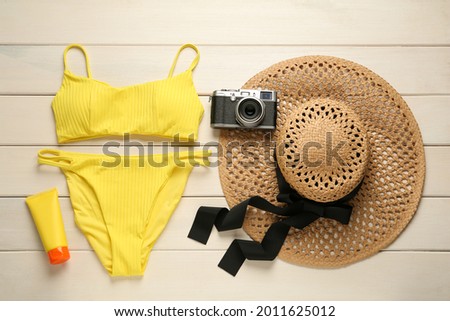 Different beach objects on white wooden background, flat lay