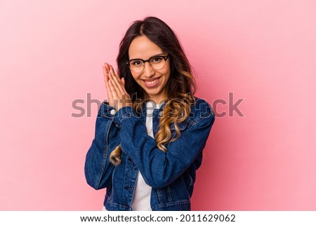 Young mexican woman isolated on pink background feeling energetic and comfortable, rubbing hands confident.